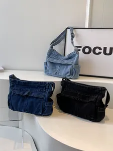 Retro denim multi-pocket tote bag in blue and black colors with adjustable strap