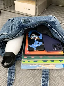 Large capacity washed blue denim messenger bag holding tablet and daily items