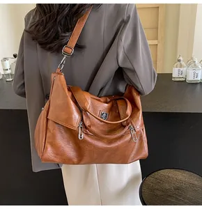 Brown large capacity tote bag worn by model showing size and adjustable strap detail