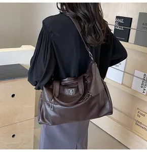 Deep brown retro oversized tote bag in pebbled faux leather with adjustable strap