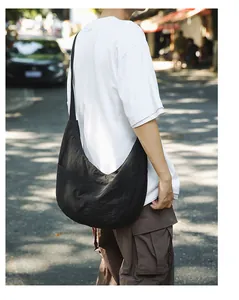 Side view of large black waterproof nylon crescent hobo bag for outdoor casual wear