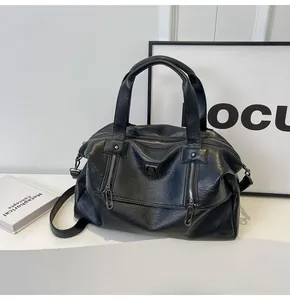 Close-up of black faux leather tote with crinkled texture and dual handles