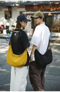 Modern nylon crescent crossbody bag shown in bright yellow and classic black styles