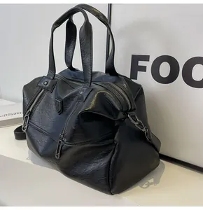 Macro view of black large capacity faux leather tote bag with reinforced handles and zippers