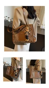 Brown monogram tote bag with leather patch, stylish rabbit charm, and long shoulder strap