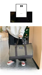 Detailed view of the large capacity canvas travel bag with faux leather base and dual handles