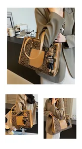 Detail view of the vintage monogram tote bag with a checkered bunny keychain accessory