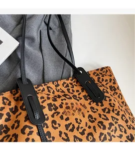Detail of leopard print tote bag showing soft faux suede texture and black straps