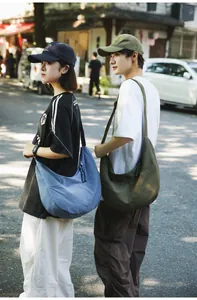 Nylon crescent crossbody bags in blue and olive green shown on models in a casual setting