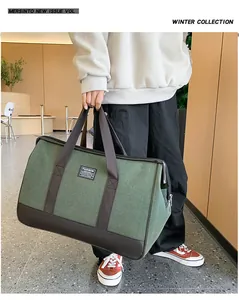 Detailed shot of large capacity travel bag in military green canvas with leather handles