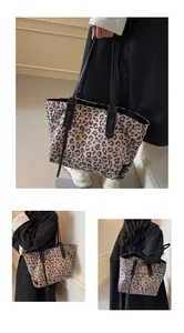 Detailed view of large leopard print tote bag showing canvas texture and black straps