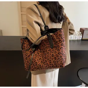 Fashionable leopard print tote bag on model's shoulder with large capacity and straps