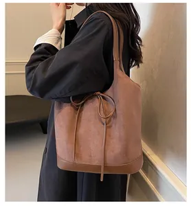 Detail of a large bow tote bag featuring premium matte texture and side-worn display