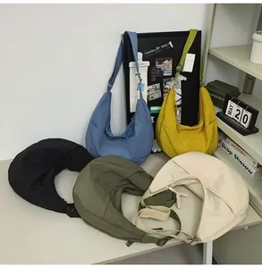 Collection of nylon dumpling bags in five colors including black, blue, and yellow
