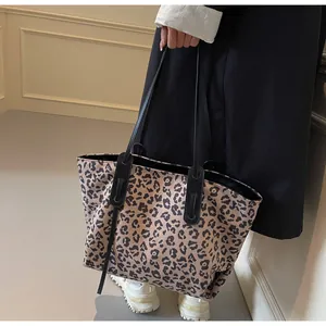 Detailed view of leopard print tote bag texture and reinforced black shoulder strap
