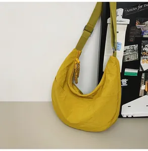 Detail of bright yellow nylon dumpling bag with textured fabric and matching zipper
