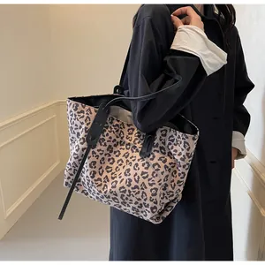 Fashionable large leopard print tote bag styled with a professional trench coat