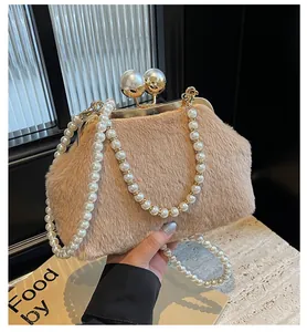 Détail d'un sac en peluche beige avec cadre doré et fermoir à perles élégantes