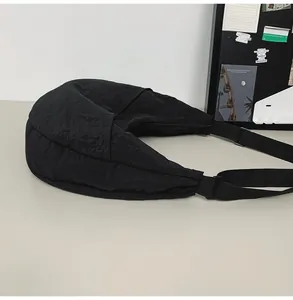 Macro detail of the durable black waterproof nylon fabric and adjustable wide strap