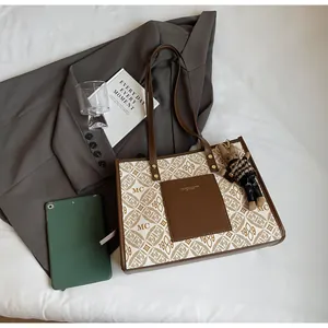 Detail of vintage logo tote bag with canvas pattern, leather pocket, and rabbit charm