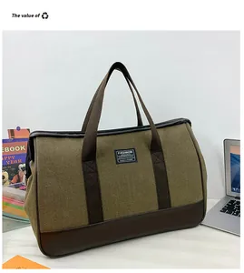Close-up of olive canvas travel bag with leather trim and dual handles for weekend trips