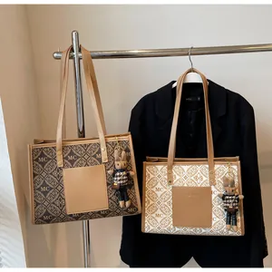 Detail view of vintage tote bags with MC patterns and cute rabbit charm on a suit