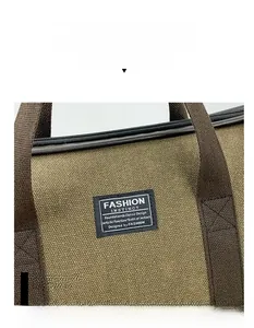 Detail of canvas travel bag with leather trim and Fashion Instinct logo tag