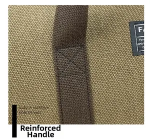 Close-up of reinforced handle stitching on a large khaki canvas travel bag