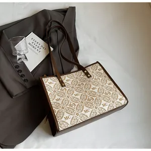 Close-up of vintage canvas tote bag with MC 1989 monogram and brown faux leather trim