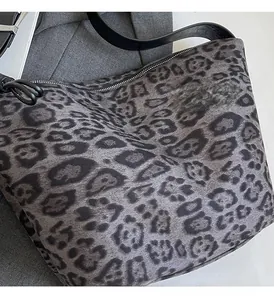 Gros plan du sac à bandoulière léopard avec tissu texturé et détails de fermeture éclair argentée