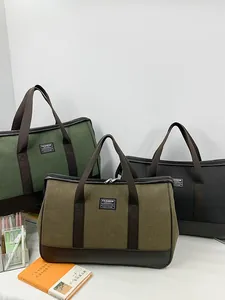 Large canvas travel bags in green and black with leather details and top handles