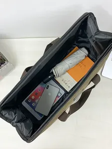 Large capacity canvas travel bag interior with tablet, book, and umbrella storage
