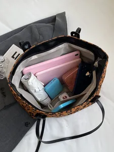 Spacious leopard print tote bag with multiple inner pockets showing large capacity