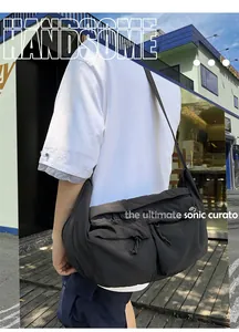 Detailed view of black nylon crossbody bag with dual zippered pockets and wide strap