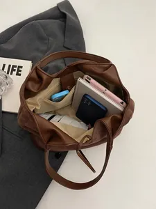 Brown matte bucket tote bag with spacious interior for daily essentials and tablets