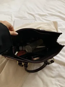 Deep brown faux leather tote bag with large capacity and internal organization layout
