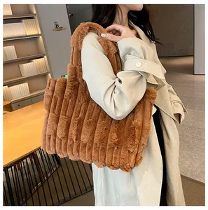 Detail of caramel plush tote bag featuring vertical ribbed texture and soft fabric