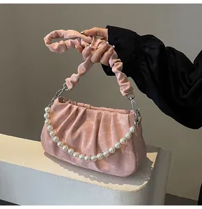 Pink pleated crossbody bag featuring elegant pearl chain strap and soft cloud texture