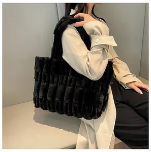 Close-up of the thick faux fur texture and vertical pleats on this black winter tote bag