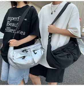 Detail of silver and black nylon crossbody bags with adjustable straps and front pockets