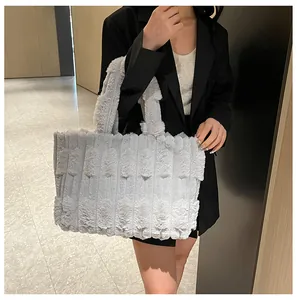 Detail of grey plush tote bag with striped faux fur texture shown in a modern interior