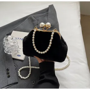 Détail du sac en fausse fourrure noire avec cadre doré et grand fermoir en perles
