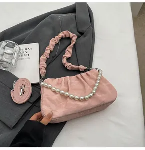 Pink pleated dumpling bag detail with pearl chain and scrunchie strap on blazer