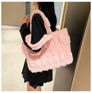 Detail of pink plush tote bag showing wide vertical stripe quilting and soft faux fur texture