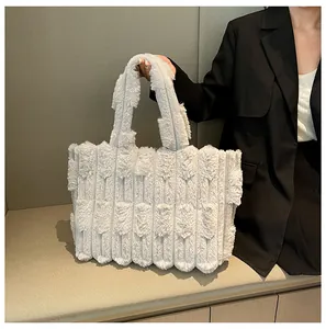 Detailed view of large grey plush tote bag with striped texture and soft faux fur material
