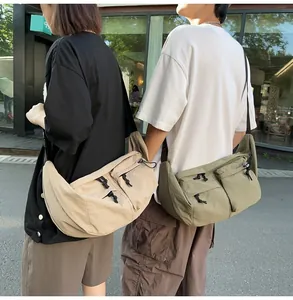 Outdoor shot of large nylon messenger bags in khaki and green with cargo pockets