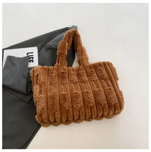 Detailed macro view of the brown plush tote bag with its soft vertical striped faux fur texture