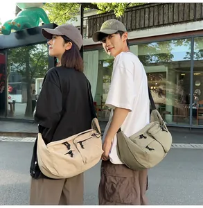 Outdoor shot of beige and olive green crossbody nylon bags with functional pockets