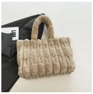 Close-up of beige plush tote bag featuring a soft vertical ribbed texture and furry handles
