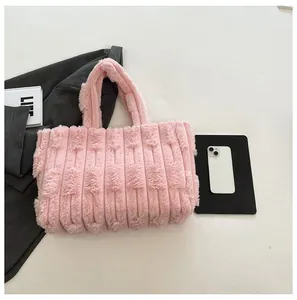 Detail view of pink plush tote bag with vertical quilting showing soft texture and large capacity